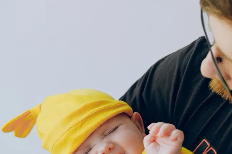 Why Does My Baby Cry Constantly and Can't Be Soothed? 3 Father holding a crying newborn who cannot be soothed